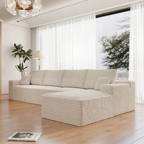 Modern white sofa in a bright living room with large windows.